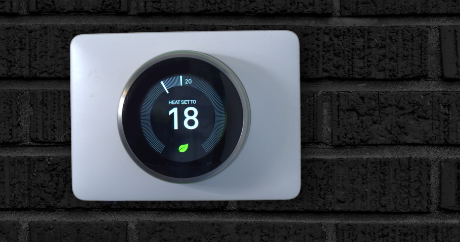 4k Smart Thermostat with a guy increasing the temperature on a black brick wall Royalty-Free Stock Footage #1041944368
