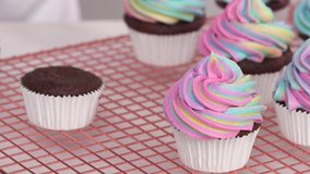 Step by step. Frosting unicorn chocolate cupcakes with rainbow color buttercream frosting. - Powered by Shutterstock - Get 15% off with code: PIKWIZARD15