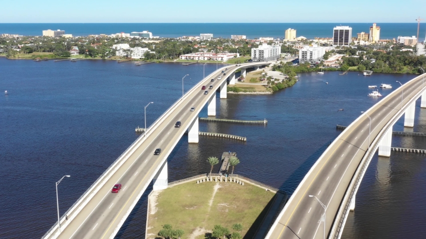 Aerial 4k footage of Daytona Beach crossing the Halifax River and heading to the the beach