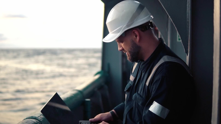 Marine chief officer or captain on deck of vessel or ship watching laptop. Internet and home connection at sea. Royalty-Free Stock Footage #1041989146