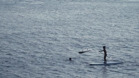 a couple having fun with sea board surfing