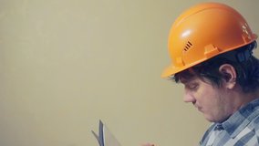 middle aged man in a construction helmet. video portrait of a builder