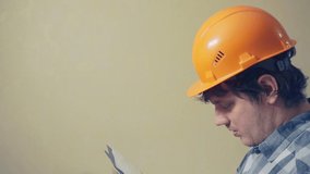 middle aged man in a construction helmet.video portrait of a builder