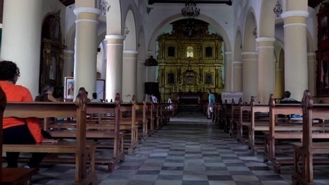 Unidentified people in the Dulce Nombre de Jesus church in the colonial part of Petare district in Caracas, the capital of Venezuela, circa Mach 2019