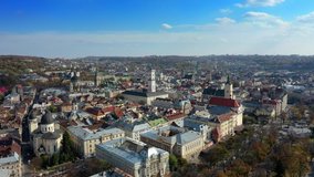 Aerial drone video of Lviv Old City center - roofs and streets, city hall Ratusha