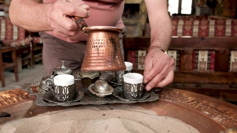 Turkish coffee making video. Turkish coffee brewing process in the sand and elderflower syrup.
