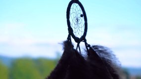Slow Motion View Of Dream Catcher Hanging From Rear view Mirror Inside Car. Dream-catcher waving in the wind in the sunset sunlight. View of the road and sunset ligh. Travel by car. Road trip concept. - Powered by Shutterstock - Get 15% off with code: PIKWIZARD15