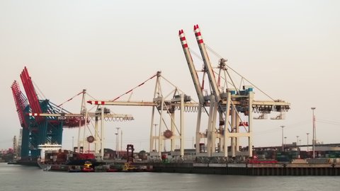 From day to night timelapse video of work on unloading containers in a cargo seaport ,Hamburg, Germany