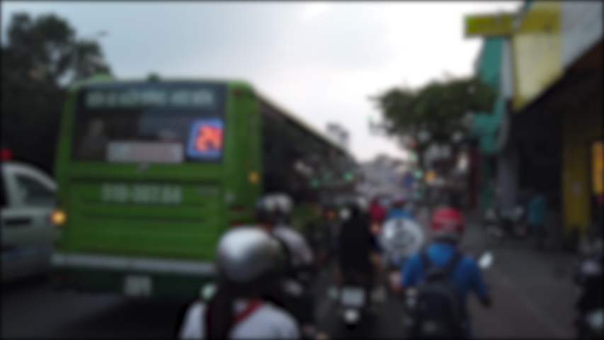 Blurred footage of transport in Ho Chi Minh. Travel in Ho Chi Minh city by a motorbike. Royalty high-quality free stock footage of slow moving traffic with lots of motorcycles, motorbike, bus, car | Shutterstock HD Video #1042042516