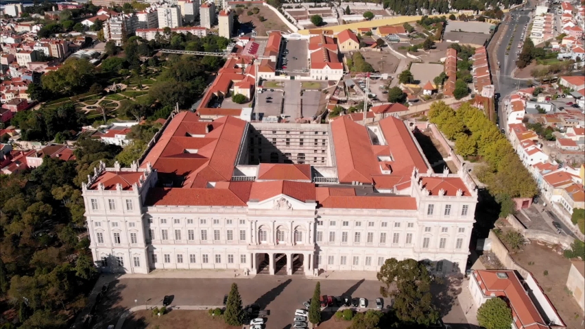 Portugal historic touristic attracton Palácio da Ajuda royal palace in Lisbon with cityscape on background, aerial view baroque rococo style facade, 