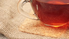 New Year and Christmas decoration. Some pine cones, branches of Christmas tree, cinnamon sticks, ribbons and flowers on a silver texture. A cup with Christmas tea on the table. Close up - Powered by Shutterstock - Get 15% off with code: PIKWIZARD15