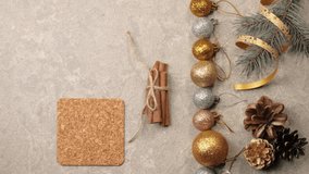 New Year and Christmas decoration. Some pine cones, branches of Christmas tree, cinnamon sticks, ribbons and flowers on a silver texture. Hand puts a cup with Christmas tea on the table. Top view - Powered by Shutterstock - Get 15% off with code: PIKWIZARD15