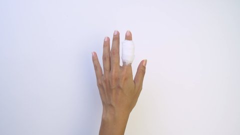 Young woman with Injured painful finger and bandage