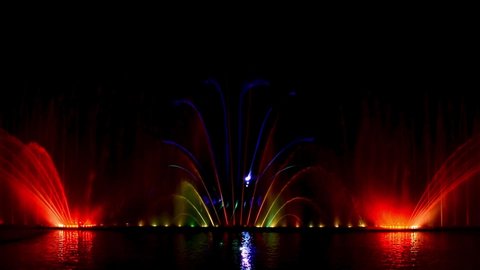 Musical fountain with laser animations. Evening show Roshen fountain. Night laser fountain show, on the Roshen embankment, the Ukrainian city of Vinnitsa.Musical fountain "Roshen" in Vinnitsa, Ukraine
