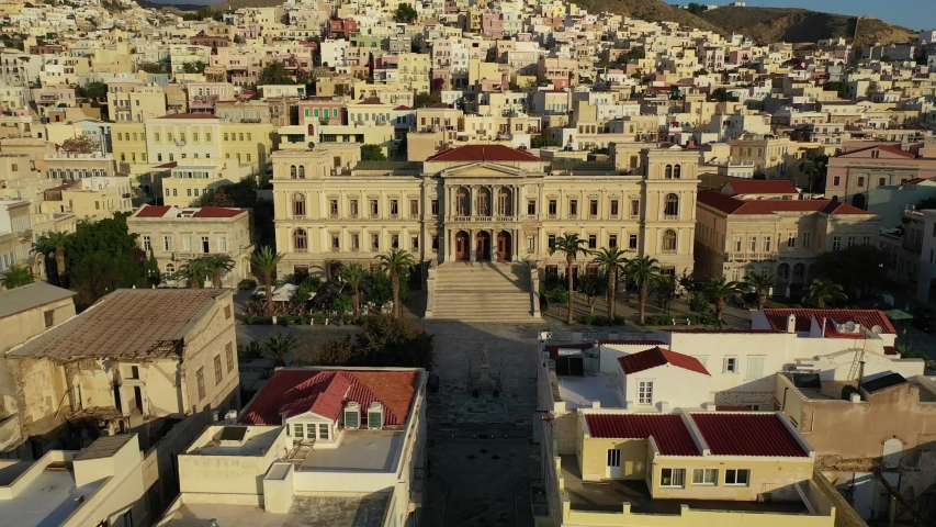 Aerial drone video of iconic landmark neoclassical city hall building in main town of Syros or Siros island - Miaouli square, Ermoupolis, Cyclades, Greece