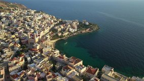 Aerial drone video of picturesque district built by the sea of Vaporia in main town of Syros or Siros island Ermoupolis and famous church of Agios Nikolaos, Cyclades, Greece