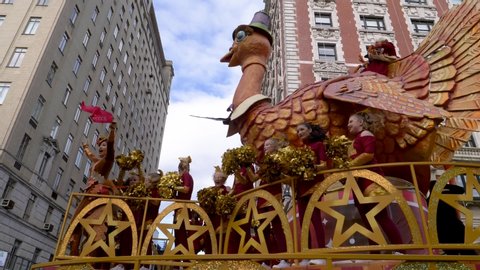 New York City, NY - November 28, 2019: Macy's Tom the Turkey Float with Pilgrims on top and kids heads within the Thanksgiving Day Parade as crowds cheer on