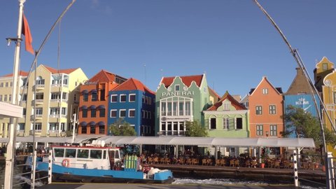 Willemstad, Curacao / Dutch Antilles -  November 18th 2019: A view on colorful buildings of Punda from the moving Queen Emma Bridge