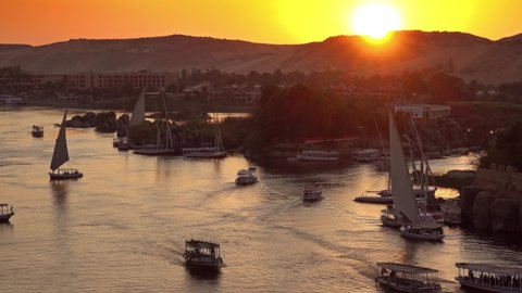 Beautiful view on felucca boats on Nile river in Aswan at sunset, Egypt, timelapse 4k