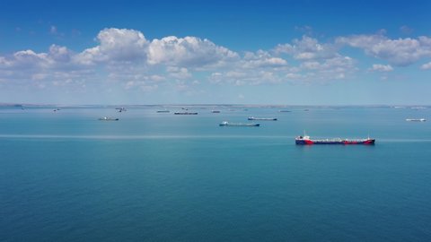 Aerial view of many cargo ships waiting for port entrance, 4k