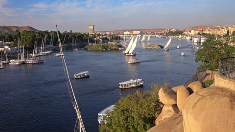 Beautiful landscape with felucca boats on Nile river in Aswan at sunset, Egypt, 4k