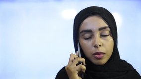 Muslim girl wearing Hijab, talking on the phone