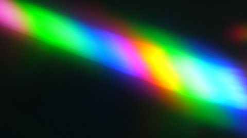 Colorful Light Beam and Ray on Black Background. Abstract Background Rainbow on CD. Beautiful Color Lens Light Rainbow Beam for Movie and Cinema at Night. Prism Separating Ray Into Colors of Spectrum.