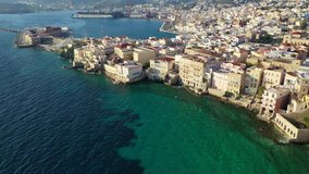 Aerial drone video of picturesque neoclassical houses district built by the sea of Vaporia in main town of Syros or Siros island Ermoupolis near famous church of Agios Nikolaos, Cyclades, Greece