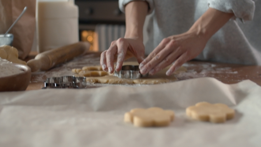 Close up of female baker hands making biscuits using baking tin in shape of flower Royalty-Free Stock Footage #1042113112