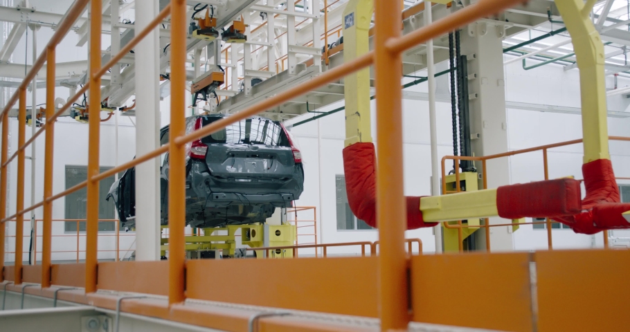BELARUS, BORISOV - AUGUST 7, 2019: Automobile plant, modern production of cars, transportation of car body on production line, robots at work, build process. | Shutterstock HD Video #1042114675