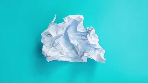 Stop motion animation with white paper crumpled on blue sky 