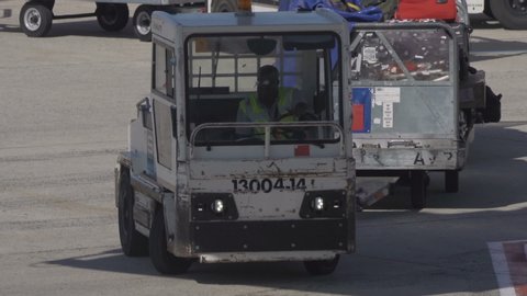 Charles de Gaulle Aiport, Paris, France - 08 08 2019: HD Airport ground support equipment - luggage cart arrives at plane