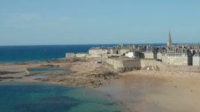 HD Aerial approach Saint Malo town over beach on beautiful summer day
