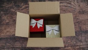 festive Christmas shopping online conceptual video, hand grabbing presents or gift boxes from inside delivery parcel