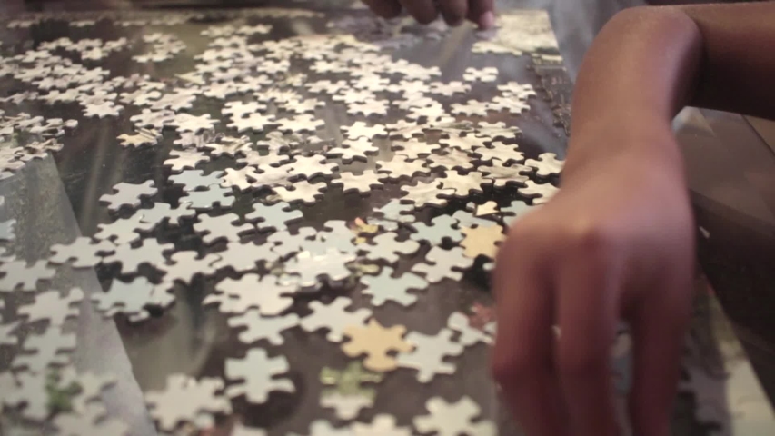 African American family putting together a puzzle Royalty-Free Stock Footage #1042132414