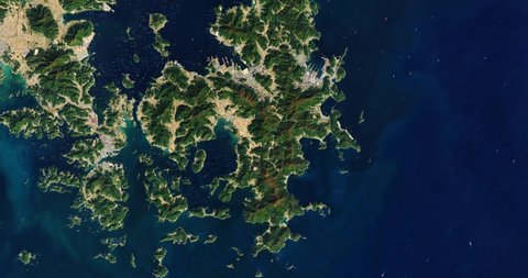 Very high-altitude overflight aerial of islands and bays along the Southern coast of South Korea. Clip loops and is reversible. Elements of this image furnished by NASA