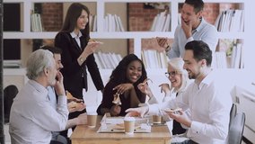 Happy international company staff enjoying break time, eating ordered pizza from cardboard box. Joyful multiracial older and young employees having fun, laughing at joke on friday party at office. - Powered by Shutterstock - Get 15% off with code: PIKWIZARD15