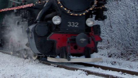 Steam train wheels close-up view in winter forest