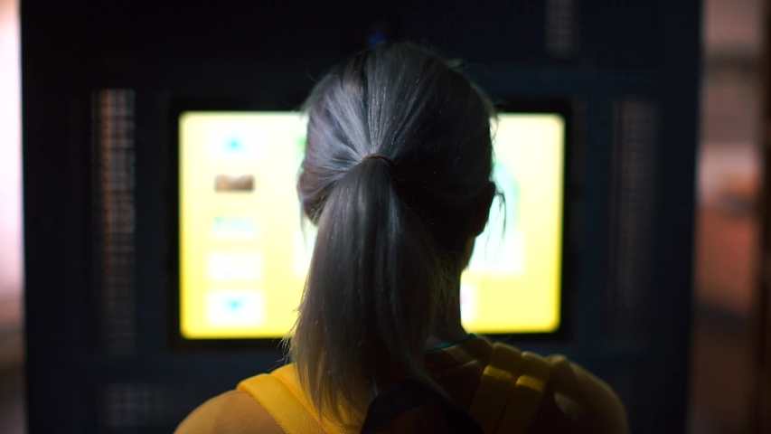 Informing the population about the epidemic of coronavirus infection COVID 19. Self-isolation during quarantine. Girl blonde, housewife, watching a commercial on the screen. Gently moves his head.