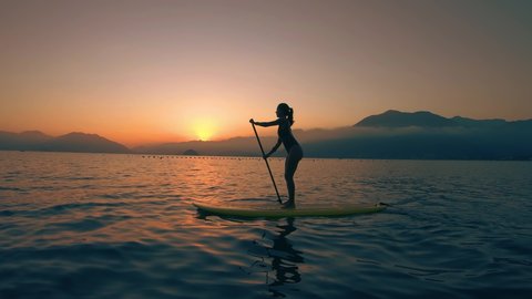 Stand Up Paddle Board Woman Silhouette on Water, Slow Motion Sunset Sea, SUP girl