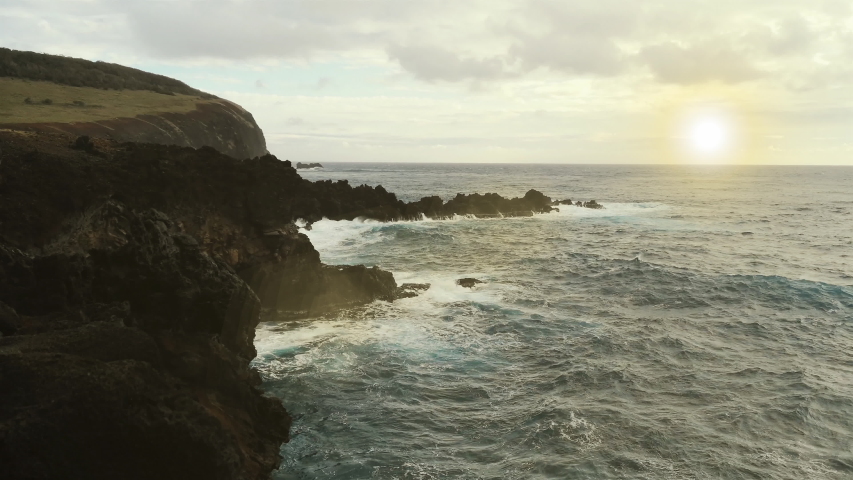 Waves Breaking on Volcanic Cliffs at Sunset at Rapa Nui Coast, Easter Island, Chile - 4K