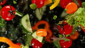 Super Slow Motion Shot of Flying Cuts of Colorful Vegetables and Water Drops on Black background at 1000fps. - Powered by Shutterstock - Get 15% off with code: PIKWIZARD15