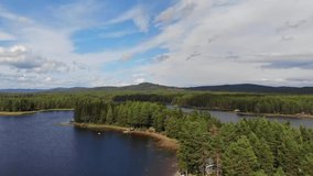 Aerial over the rivers and heavily forested areas of Dalarna County in Sweden. Drone slow pan down
