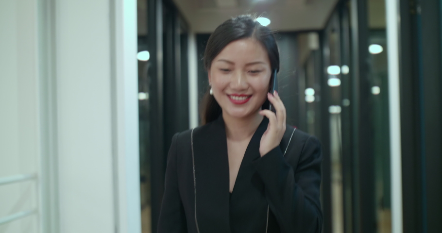 Close up following view of asian businesswoman walking fast in the office talking on the phone professional office lady working footage  | Shutterstock HD Video #1042170277