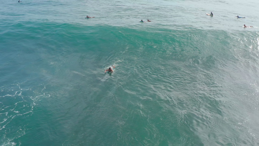 Awesome large ocean wave. Surfer riding and turning with spray on blue ocean wave. Surfing ocean lifestyle. Extreme sports. Fitness/lifestyle advertising/commercial. Extreme power of crushing waves.