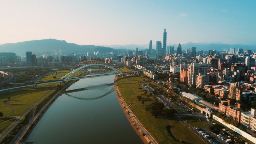Aerial hyperlapse of Rainbow bridge and busy highway with park in Taipei city, Taiwan(60P) Royalty-Free Stock Footage #1042179640