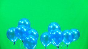 Balloons are pink then blue then white rises slowly on a green screen. Slow motion. - Powered by Shutterstock - Get 15% off with code: PIKWIZARD15