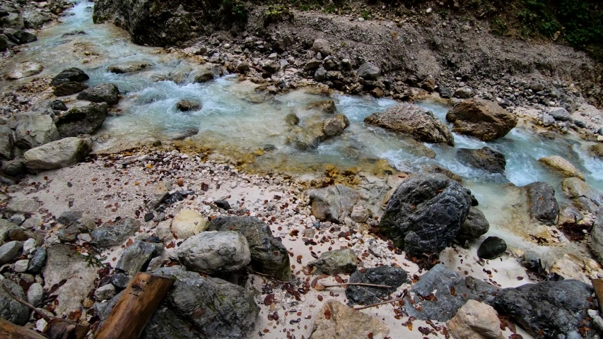 4K Slow motion forward rotation view of a small colorful pristine stream