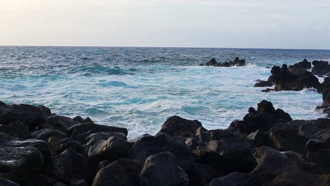 Lava stones on the beach of Piscinas Naturais Biscoitos. Atlantic Ocean. Terceira island Azores, Portugal.