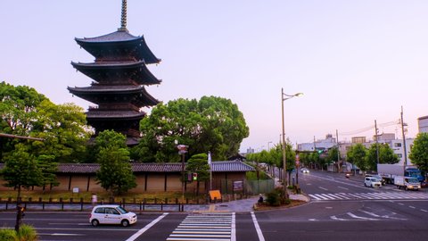 Kyoto, Japan. Car traffic in the morning in front of Toji Temple in Kyoto, Japan. Time-lapse with clear sky and cars in the sunrise